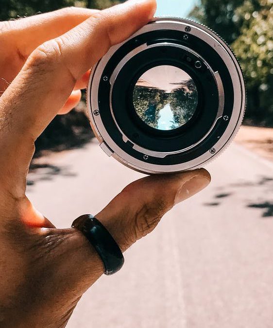 Featured Image Alt Text: A hand holding a lens that offers a different perspective symbolizing HMDA fair lending analysis. 